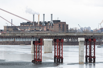 Image showing Big industrial chimney in the middle of a city