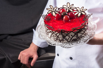 Image showing Confectioner holding delicious cake