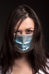 Image showing Young woman in a protective mask