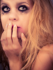 Image showing A sad blond girl with terrified expression