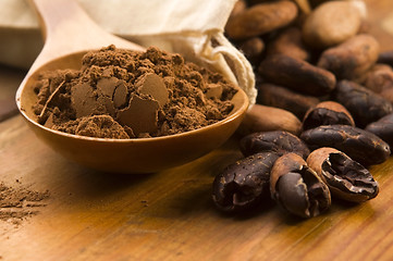 Image showing Cocoa (cacao) beans on natural wooden table