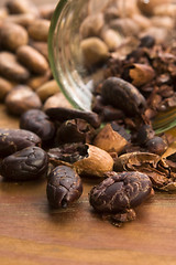 Image showing Cocoa (cacao) beans on natural wooden table