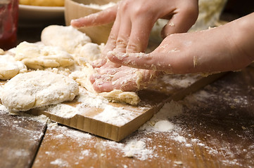 Image showing Detail of hands kneading dough