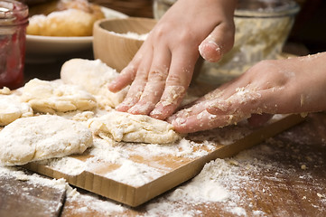 Image showing Detail of hands kneading dough