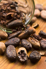 Image showing Cocoa (cacao) beans on natural wooden table