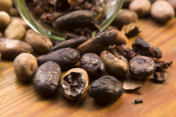 Image showing Cocoa (cacao) beans on natural wooden table