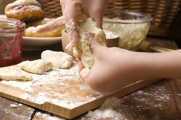 Image showing Detail of hands kneading dough