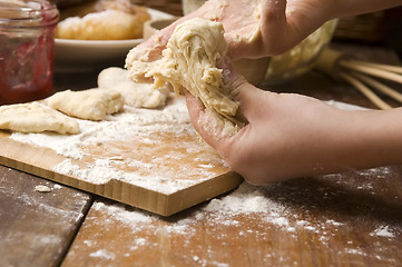 Image showing Detail of hands kneading dough