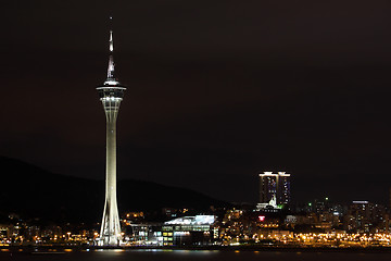Image showing Cityscape in night with famous travel tower near river in Macao,