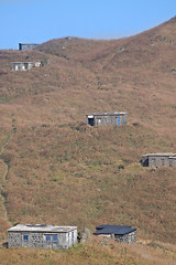 Image showing old stone house with grass on the mountain 