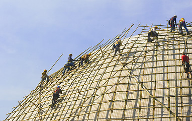 Image showing Closeup of construction worker assembling scaffold on building s