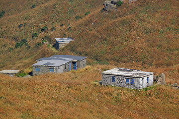 Image showing old stone house with grass on the mountain 