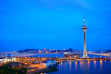 Image showing Cityscape in night with famous travel tower near river in Macao,