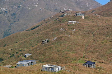 Image showing old stone house with grass on the mountain 