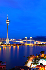 Image showing Cityscape in night with famous travel tower near river in Macao,