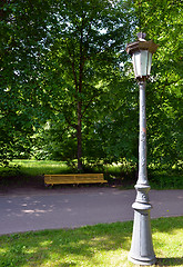 Image showing Vintage retro park lamp pole and wooden bench 