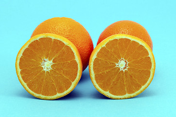 Image showing Orange fruit full and sectioned on blue background 