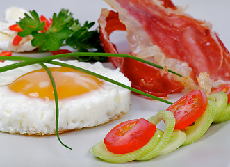 Image showing Fried Eggs Sunny Side Up with greens and bacon