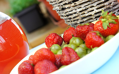 Image showing Strawberries, gooseberry, basket and compote