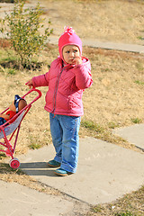 Image showing Little girl with pram