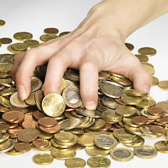 Image showing hand while gathering euro coins