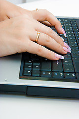 Image showing Women's hands on the laptop keyboard