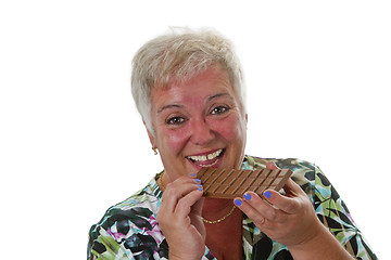 Image showing Female senior with bar of chocolate