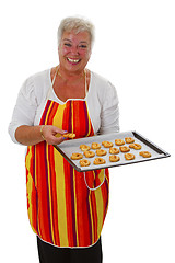 Image showing Female senior with cookies 