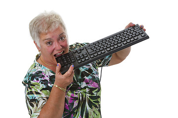 Image showing Female senior having problem with computer