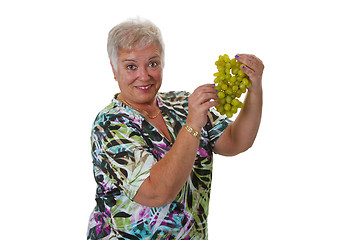 Image showing Female senior with grapes 