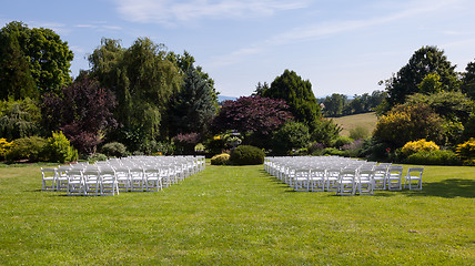 Image showing Rows of wooden chairs set up for wedding