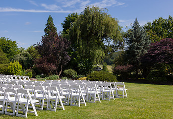 Image showing Rows of wooden chairs set up for wedding