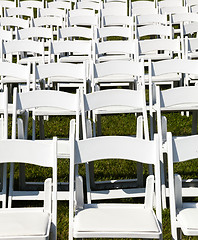 Image showing Rows of wooden chairs set up for wedding