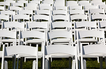 Image showing Rows of wooden chairs set up for wedding