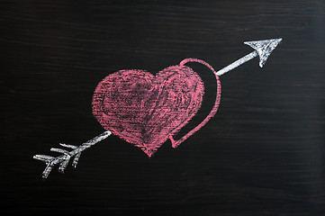 Image showing Love hearts with Cupid arrow on a chalkboard 