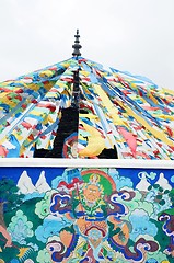 Image showing Tibetan prayer flags and ancient wall art