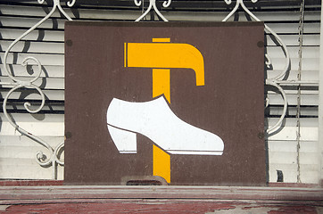 Image showing Shoe repair shop sign on window. hammer and shoe 