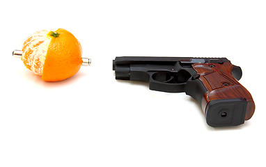 Image showing The close up of a pistol a tangerine