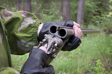 Image showing Hunter examines the old gun