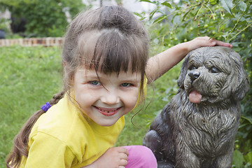 Image showing Girlie  near to concrete dog