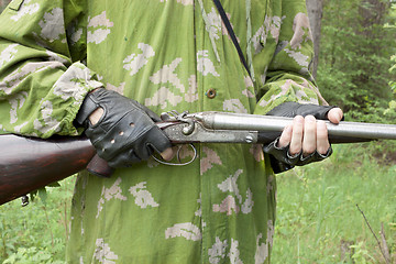 Image showing Gun in the hands of the arrow