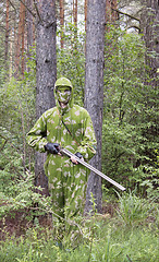 Image showing The shooter in camouflage in the forest