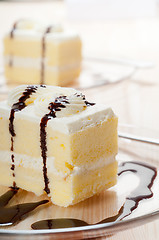 Image showing fresh cream cake closeup with chocolate sauce