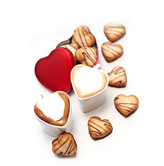 Image showing heart shaped cream cookies on red heart metal box and coffee