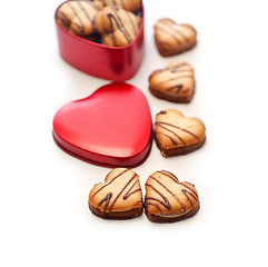 Image showing heart shaped cream cookies on red heart metal box