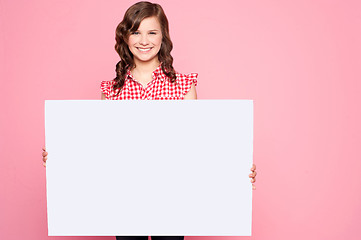 Image showing Beautiful girl holding blank billboard
