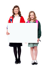 Image showing Schoolgirls holding big blank banner ad