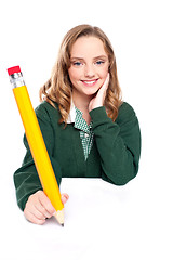 Image showing Young girl using an over sized pencil