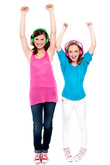 Image showing Excited young girls enjoying music together