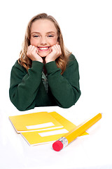 Image showing Isolated girl smiling with hands on chin